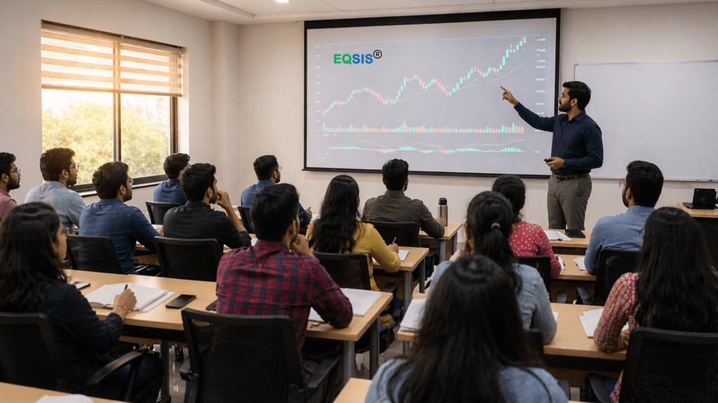 Indian stock market training classroom with trainer explaining charts on projector while students take notes in a professional learning environment